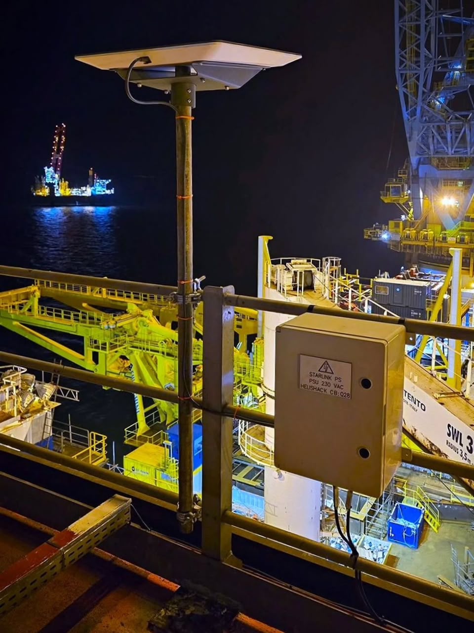 Offshore platform connectivity equipment installed at night over the sea